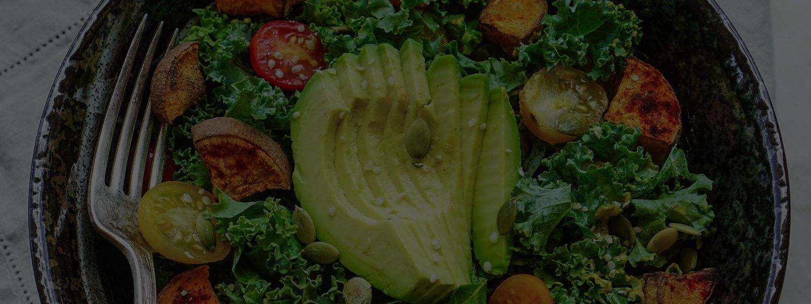 Biohack the planet – and your biology image of a salad with avocado in a bowl with a fork