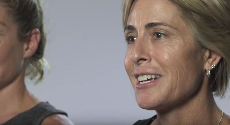 a close up of a woman 's face with a smile on her face .