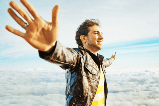 a man with his arms outstretched in the air