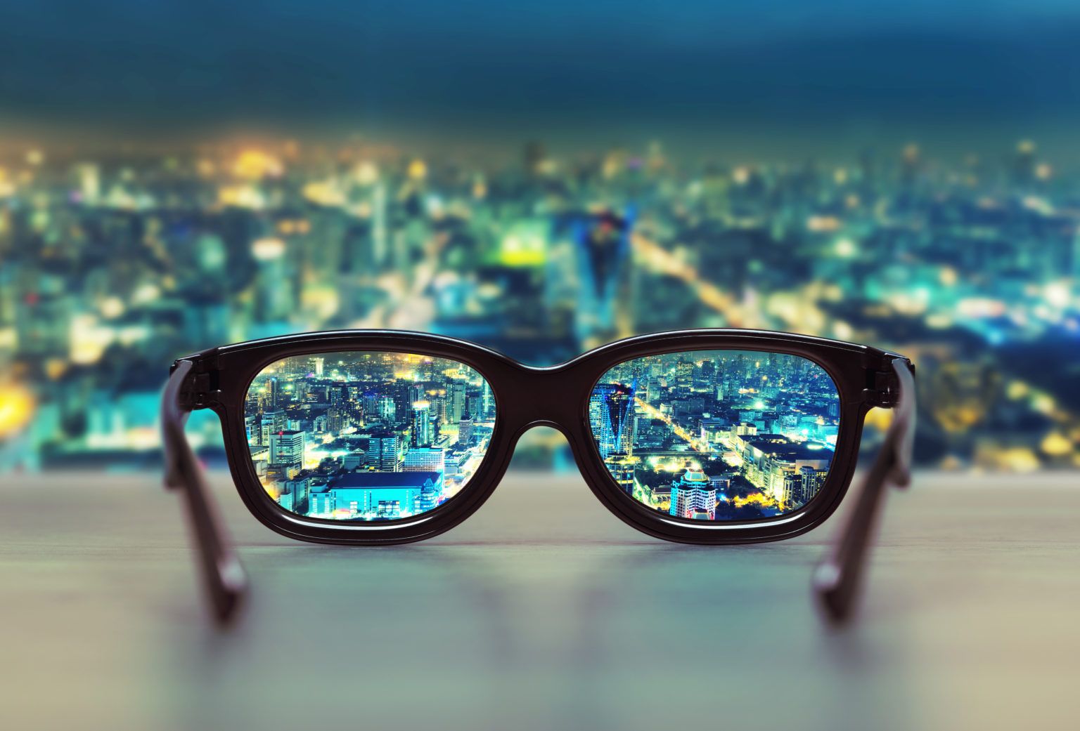 a pair of glasses with a city skyline reflected in the lenses .