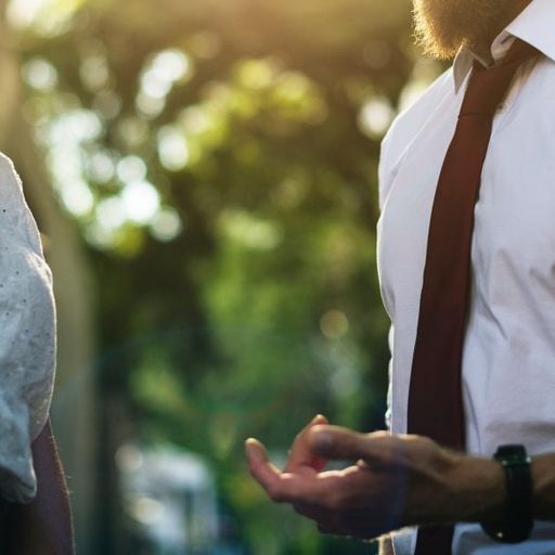 a man and a woman are talking to each other in a park .