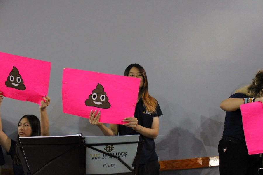 Girl holding poop emoji.
