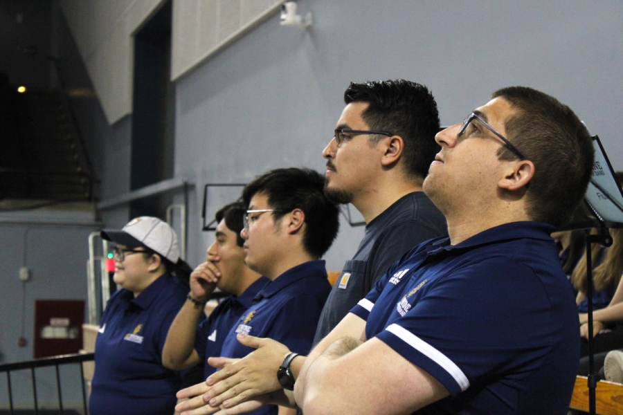 Trumpet section watching the game.