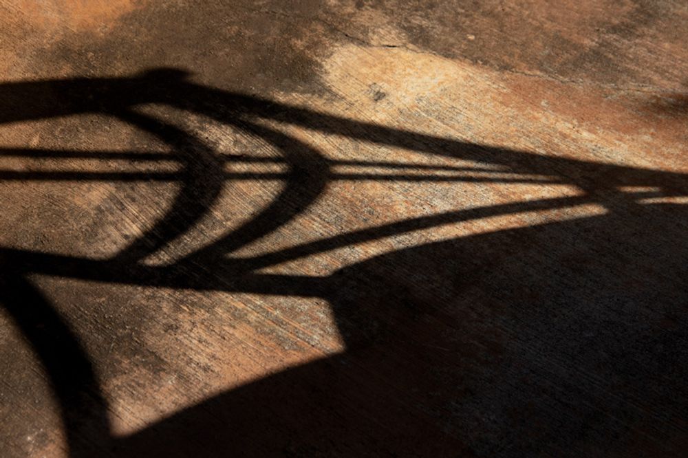 Shadow of a patio table chair.