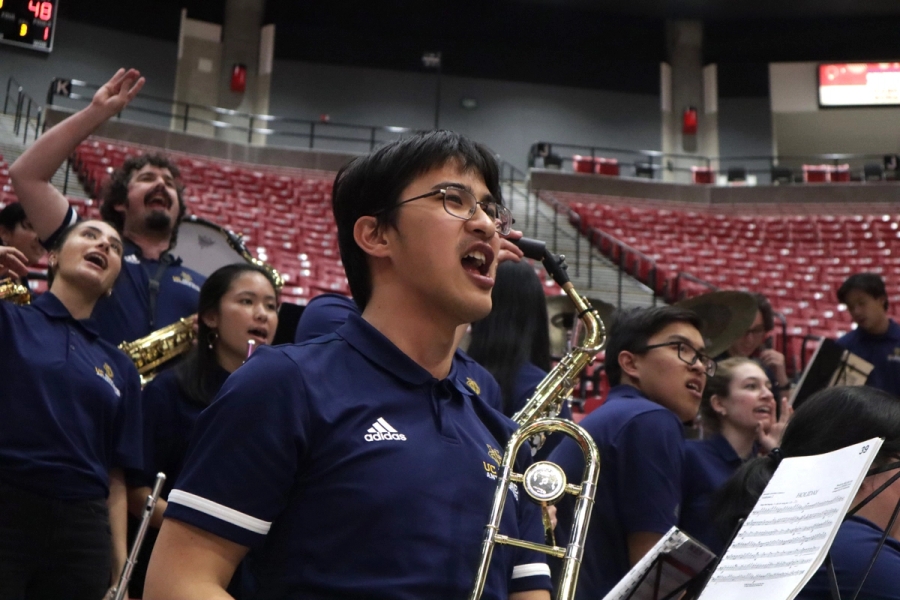 Boy with trombone yelling.