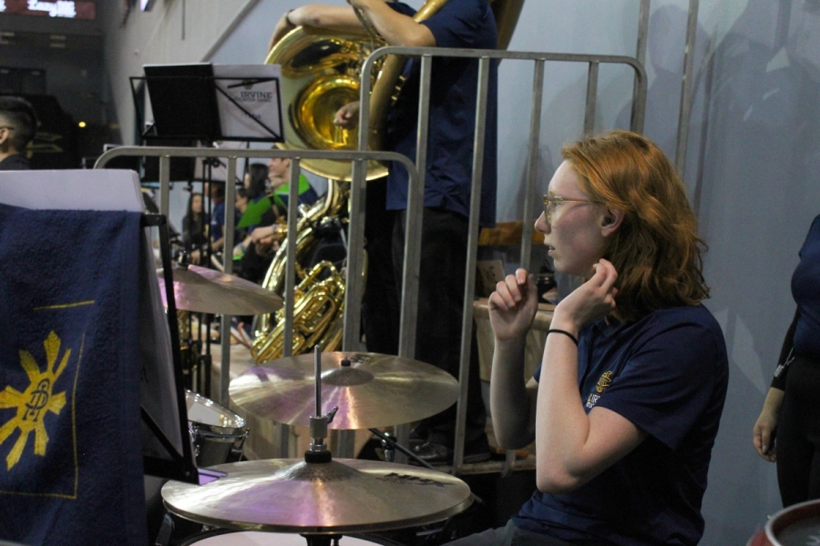 Girl on drums fixing hair.