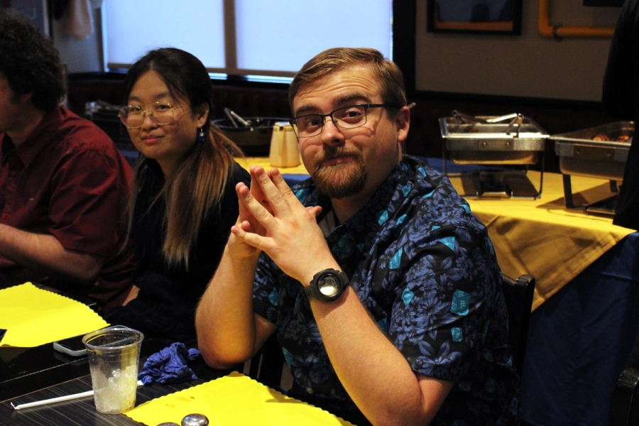 Man posing with fingers touching.