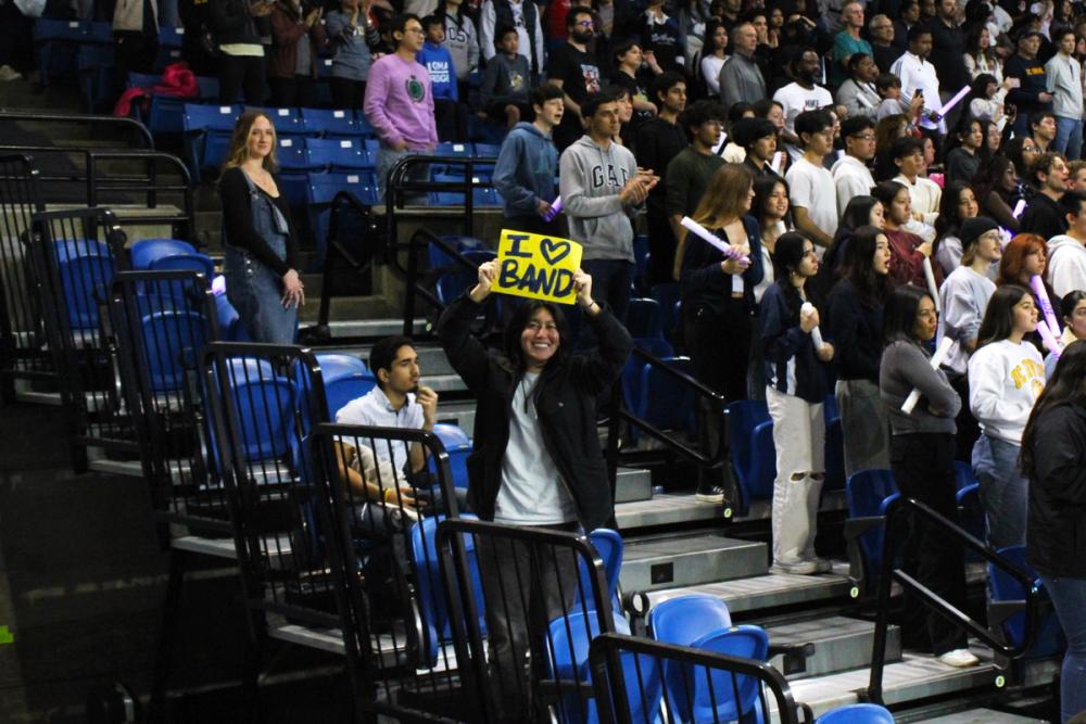 Girl holding "I <3 Band" sign in the crowd.
