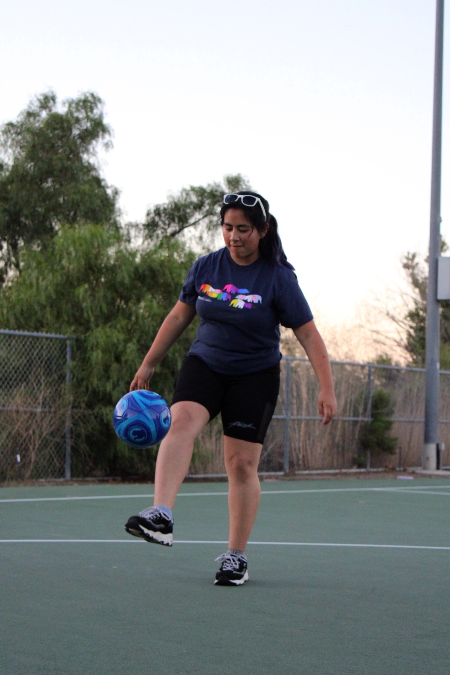 Girl kicking soccer ball.