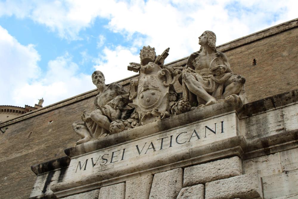 Statues on top of Italian sign.