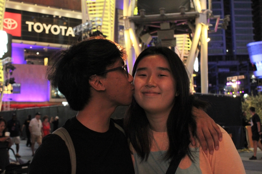 Boy kissing girl on cheek.