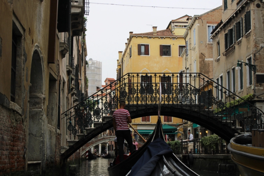 Gondola going under a bridge.