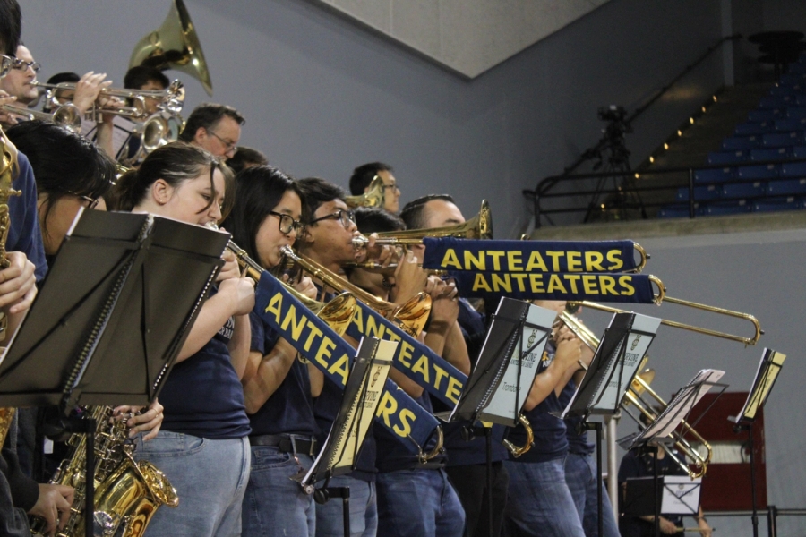 Side POV of trombones playing with slide covers.