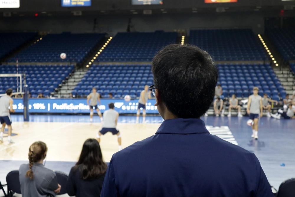 Back POV of boy watching game.