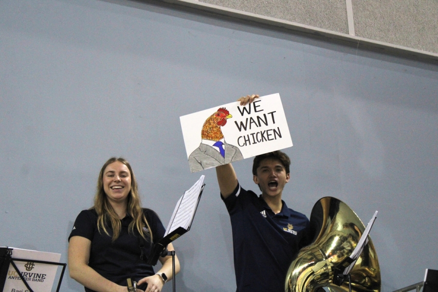 Boy holding up "We Want Chicken" sign.