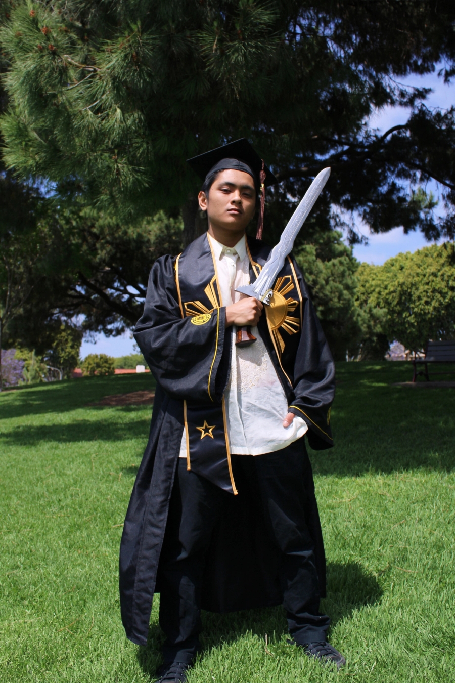 Man in Filipino grad fit with large sword 3.