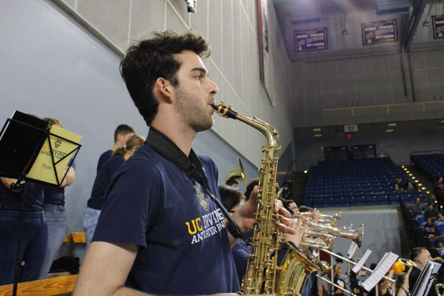 Side POV of man playing alto sax.