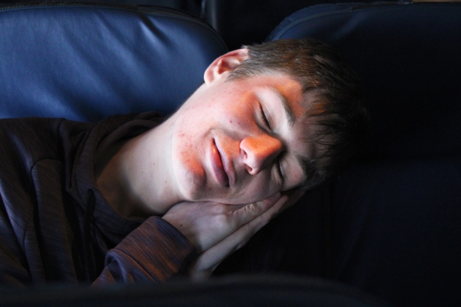 Boy sleeping on flight.