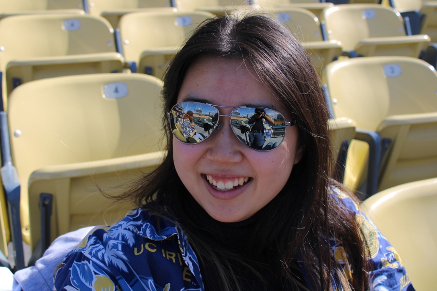 Asian girl smiles and looks left.