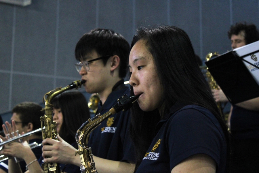 Side POV of alto saxes.