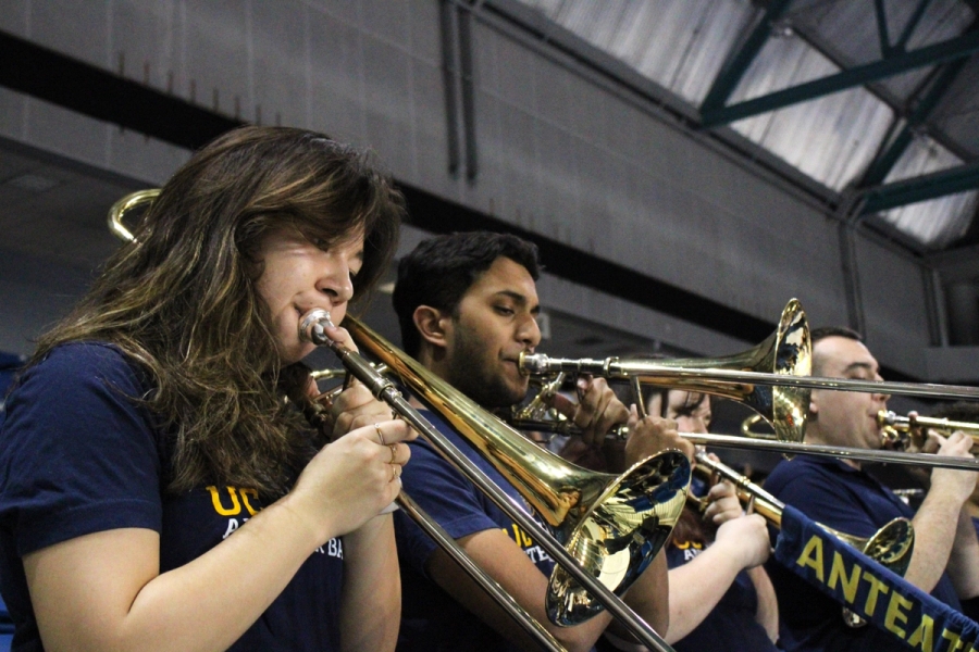 Side POV of three trombones playing.