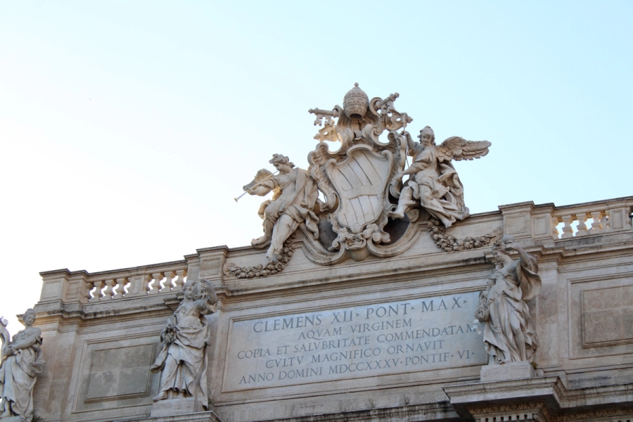 Statues on top of building.