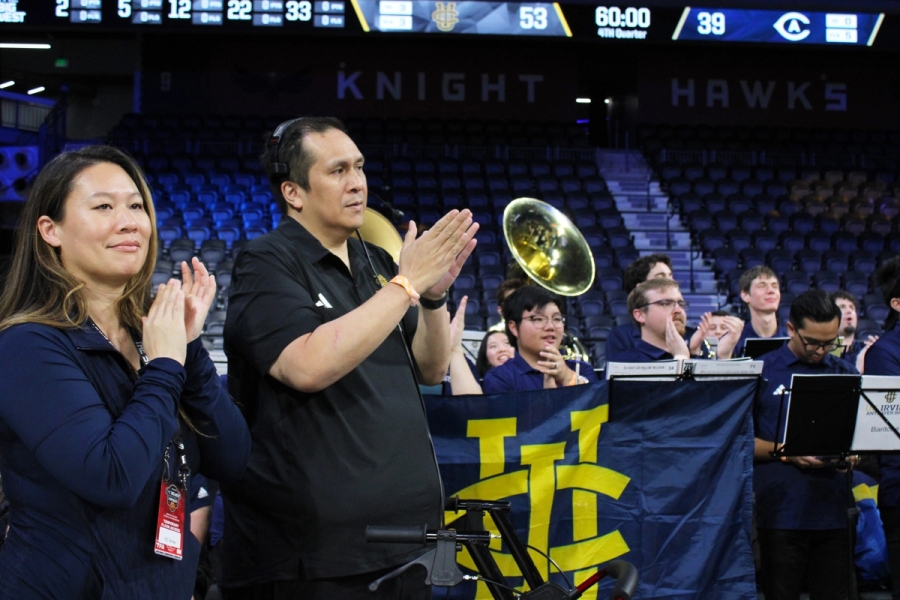 Band director and Director of Fan Experience clapping.