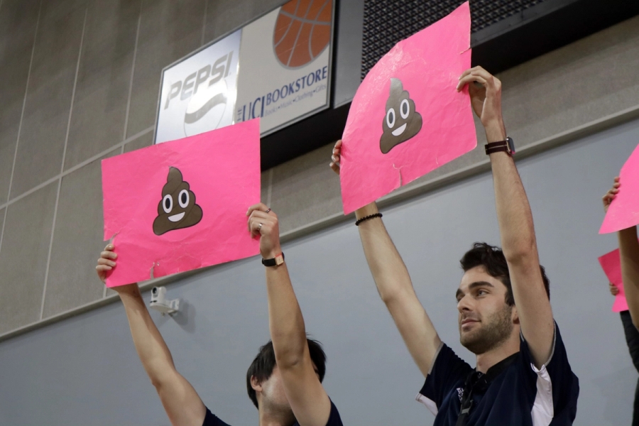 Two boys holding poop emojis.
