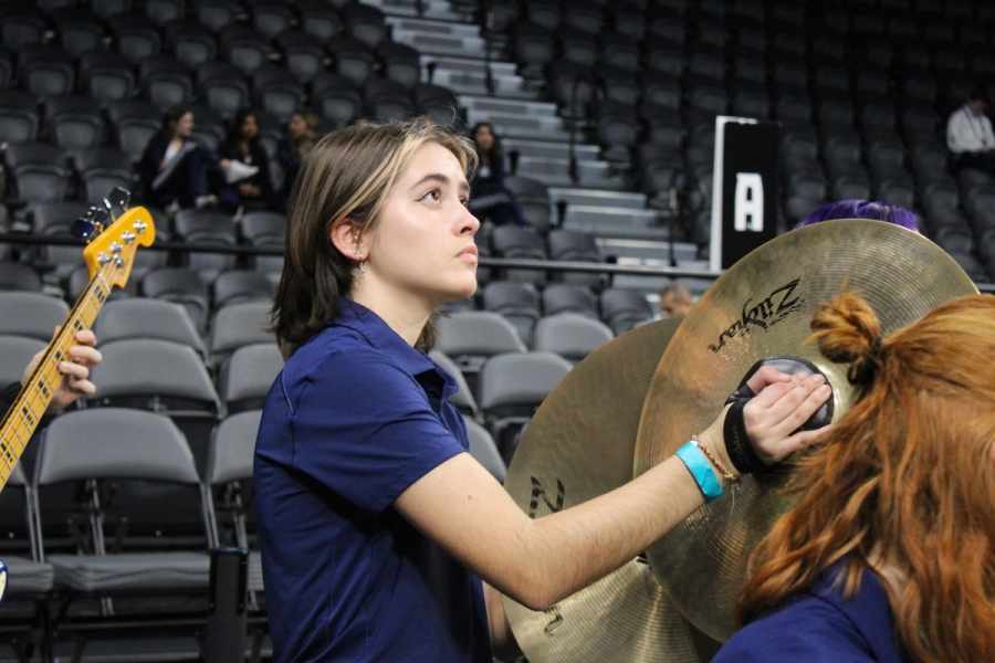 Girl playing cymbals.