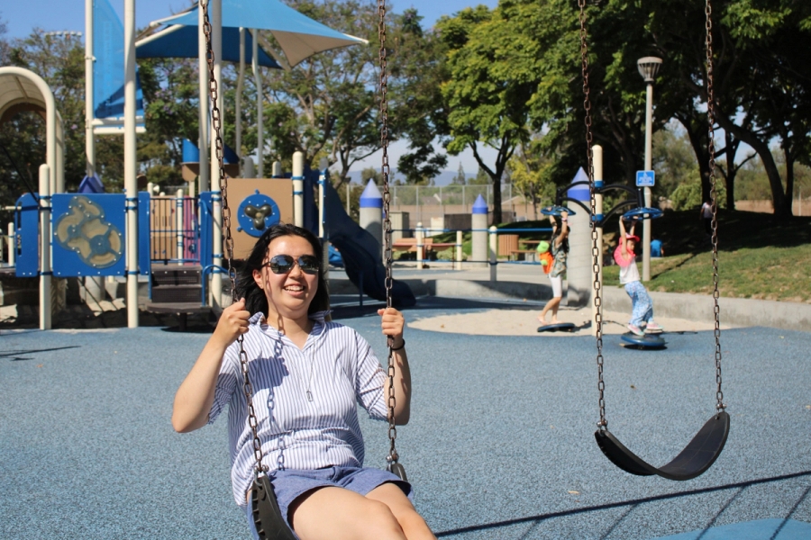 Girl smiling on swing.