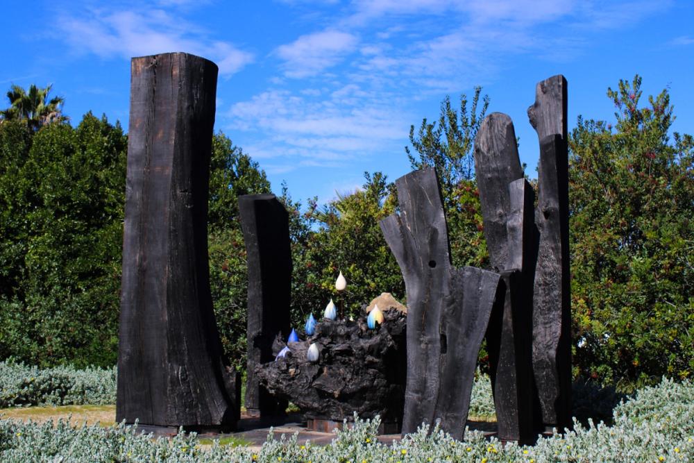 Black wood pillars surrounding items in the middle.
