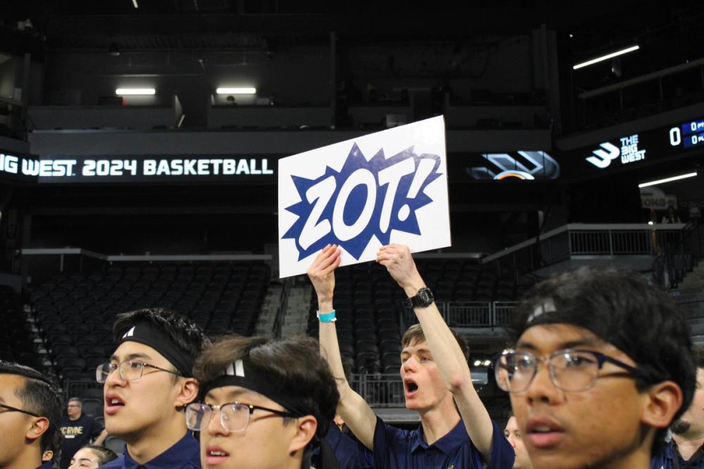 Boy holding Zot sign.