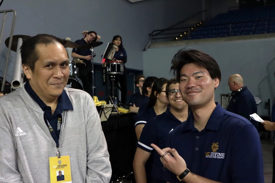 Asian boy pointing at director.