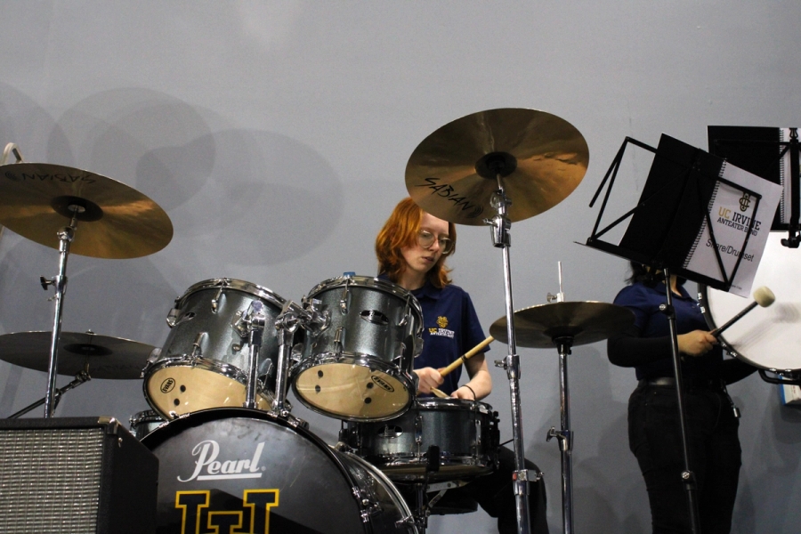 Girl on set hitting cymbals.