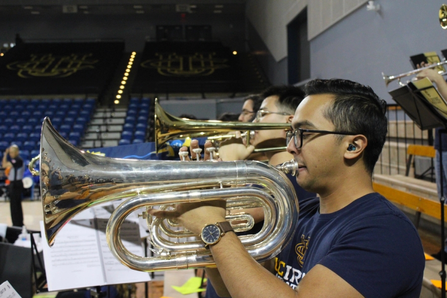 Side POV of baritone and trombones playing.