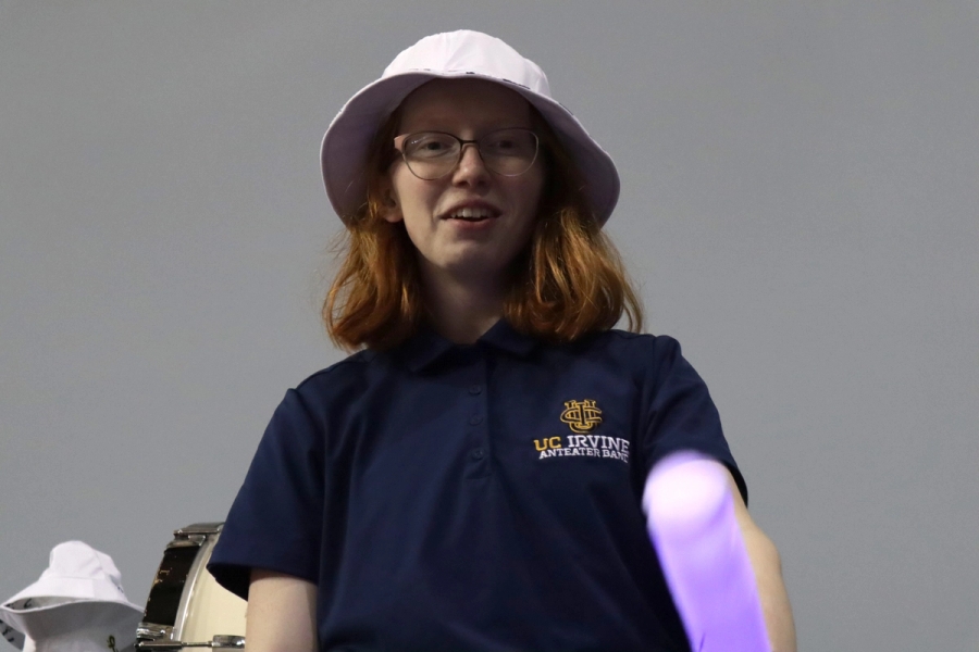 Girl wearing a bucket hat with a lightsaber.