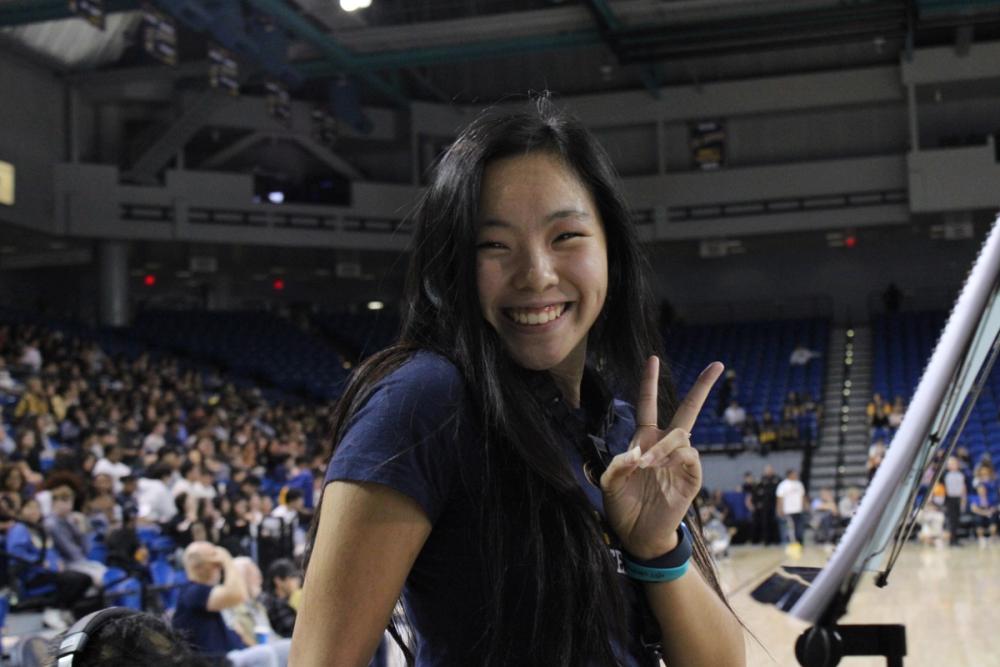 Girl holding up peace sign.