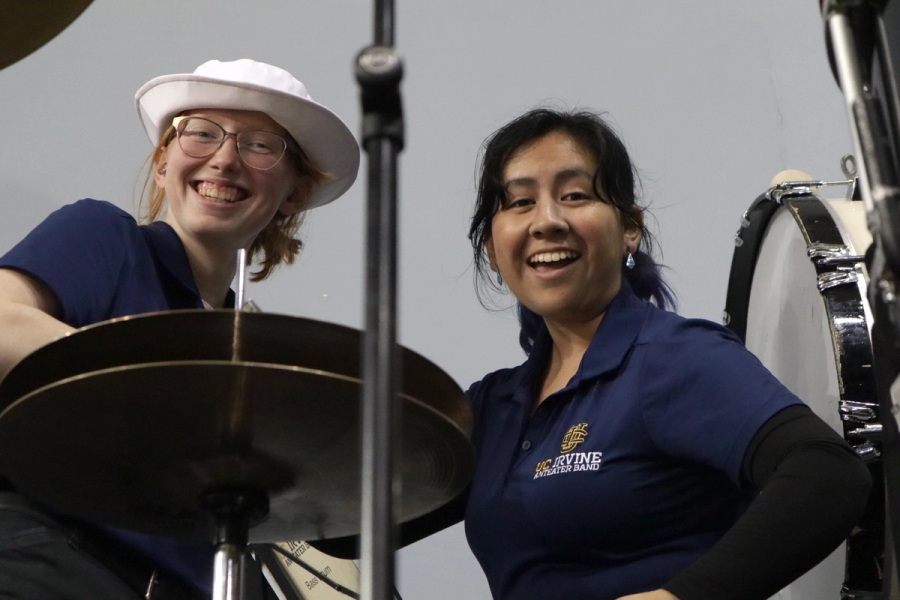 Two girls smiling near percussion equipment.
