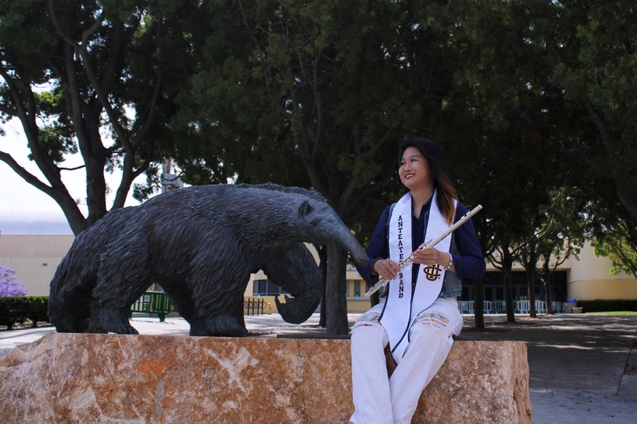 Girl holding flute and laughing.