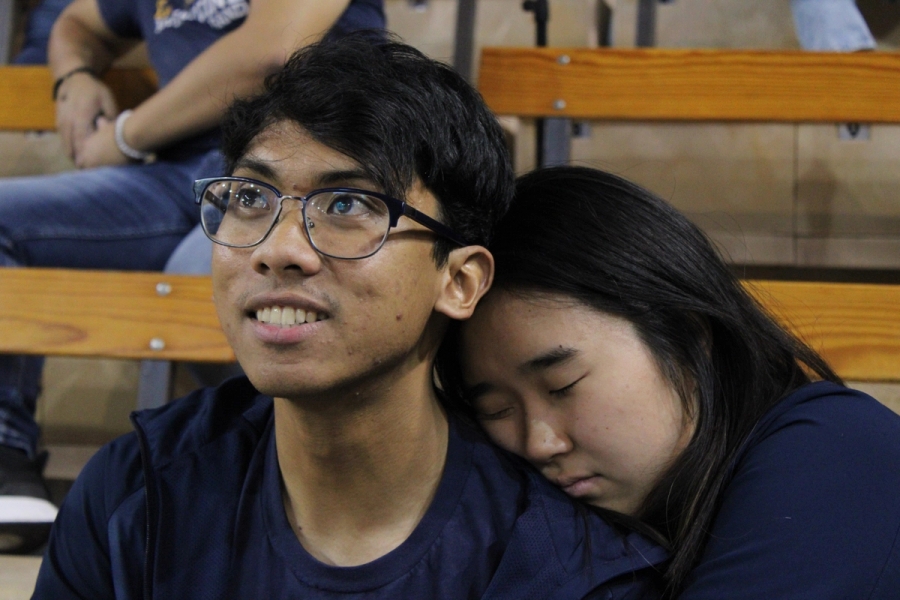 Girl resting on boy's shoulder.