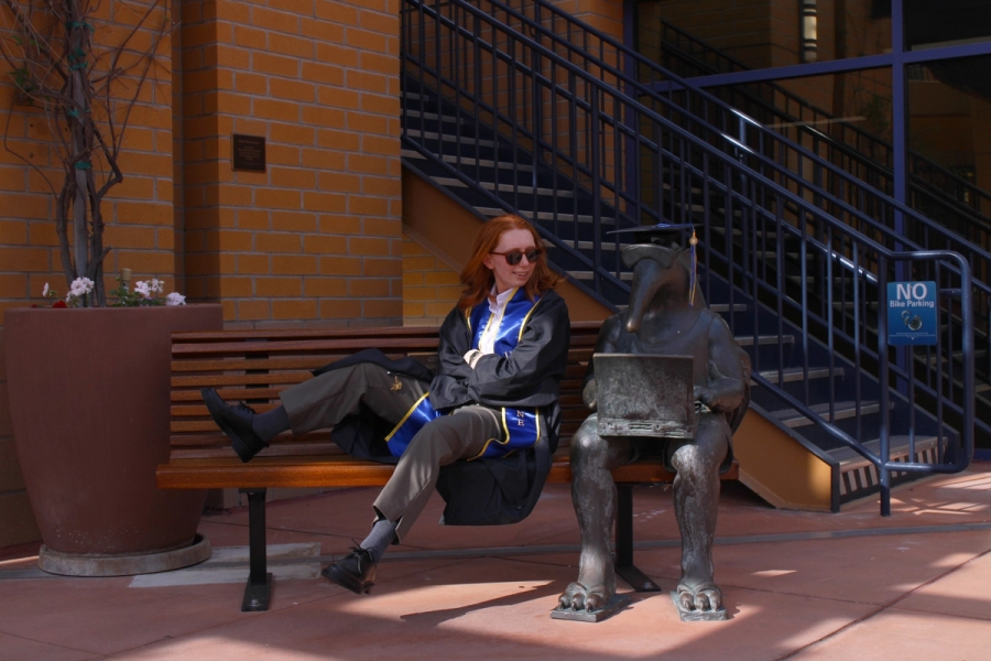 Girl staring at grad anteater statue.
