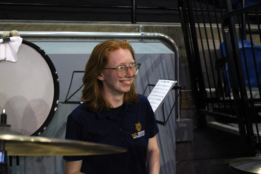 Girl smiling at drumkit.