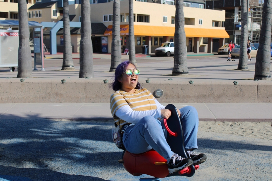 Girl riding a black and red attraction.