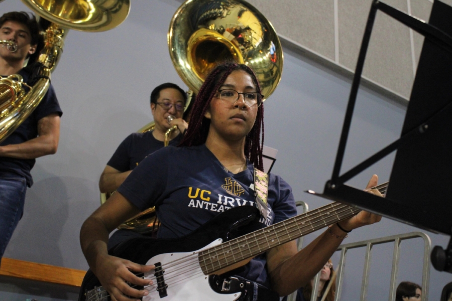 Low POV of girl playing bass.