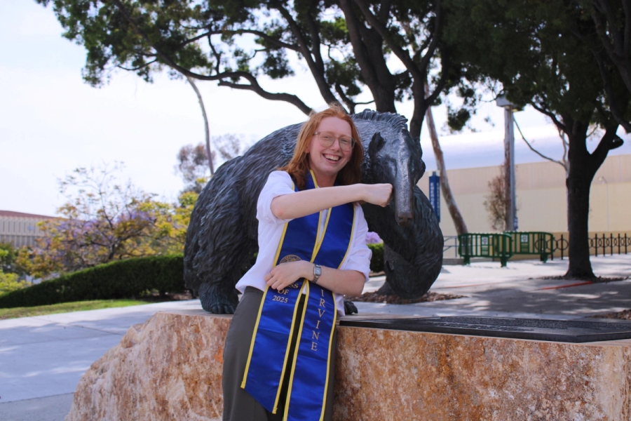 Girl fistbumping anteater statue.