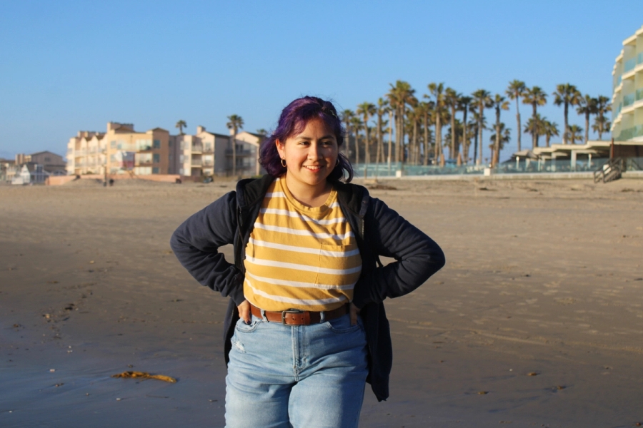 Girl standing with hands on hips.