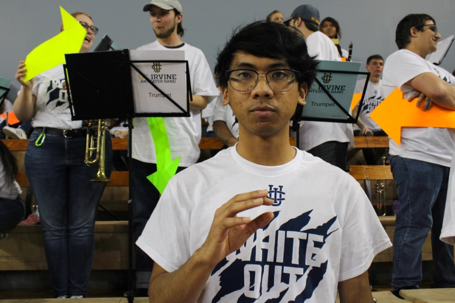Boy making weird hand gesture.