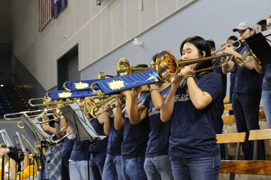 Front low POV of trombones playing.