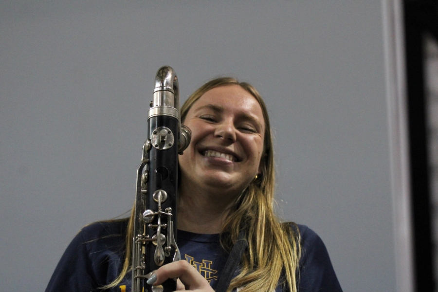 Girl with bass clarinet smiling.