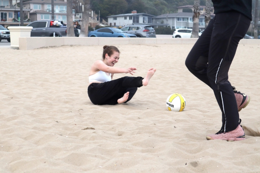 Girl laughing on the sand.